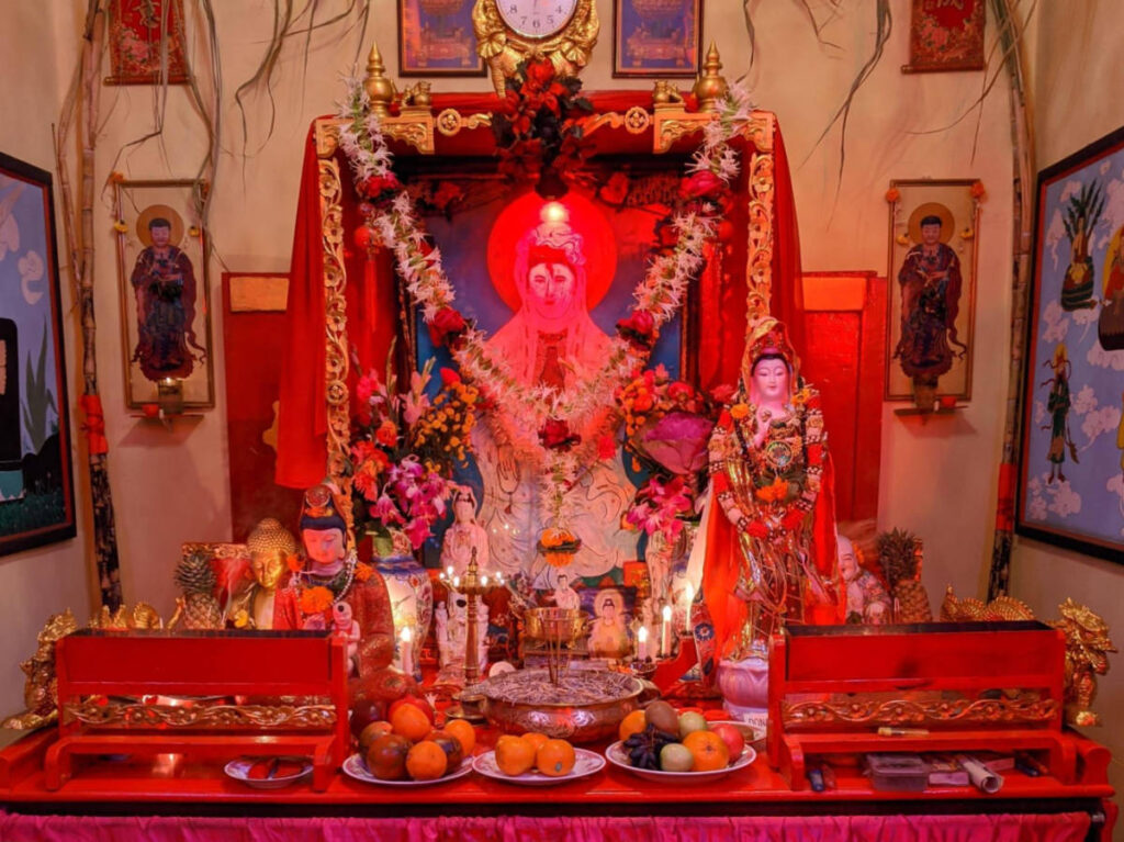 View of the garlanded photo of a Chinese deity at the Kwan Kung Chinese Temple