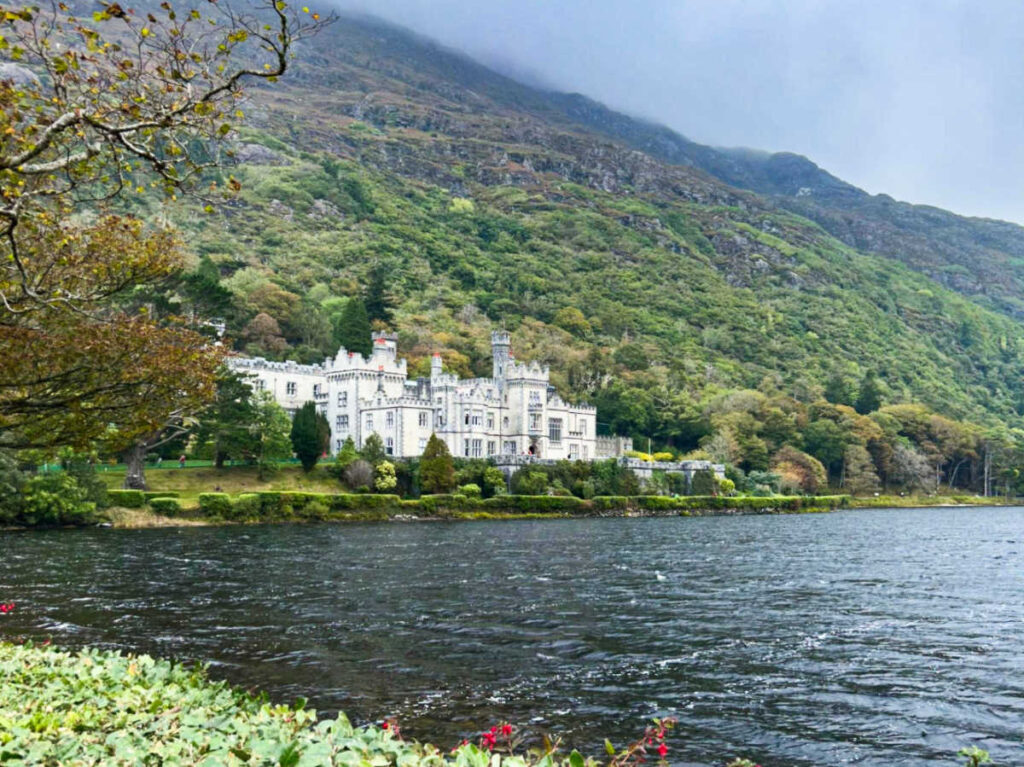 The lakefront Kylemore Abbey at the bottom of the mountain