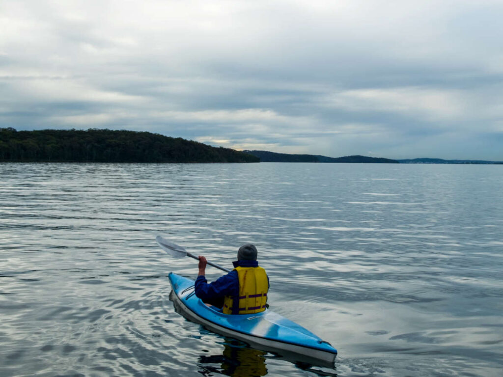 A man kayaking at the Lake Macquarie