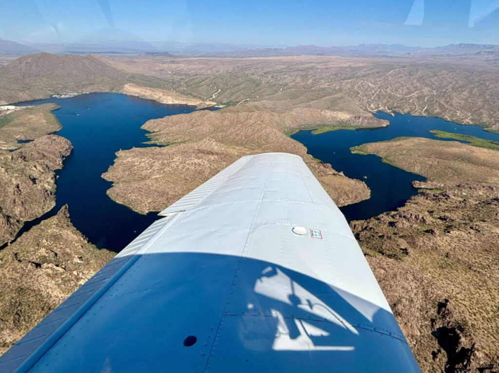 Overlooking view of the airplane wing and a lake