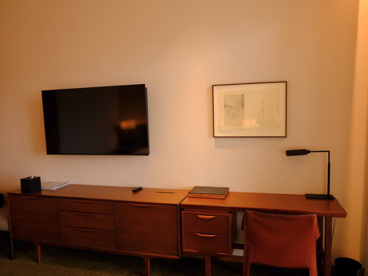 The TV above the large desk