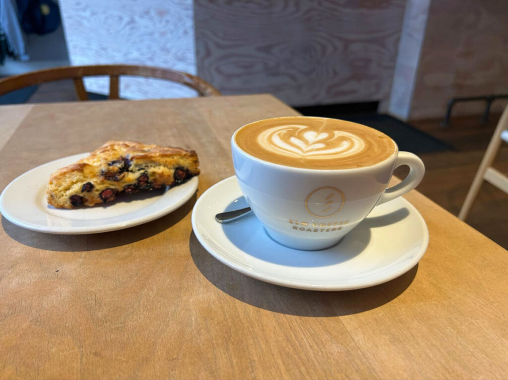 Latte and pastry on a table at Elm Coffee Roasters