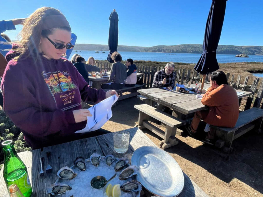 The author Laura McFarland preparing to eat a dozen of Sweetwater oysters