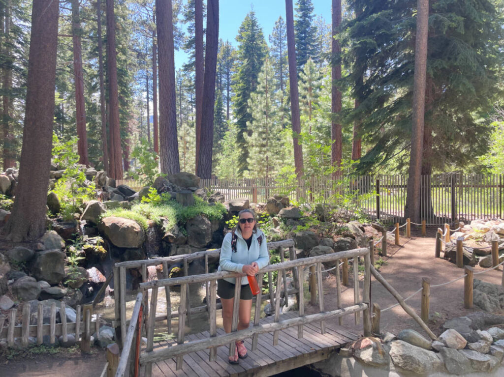 The author Laura Falin posing for a photo on a small bridge