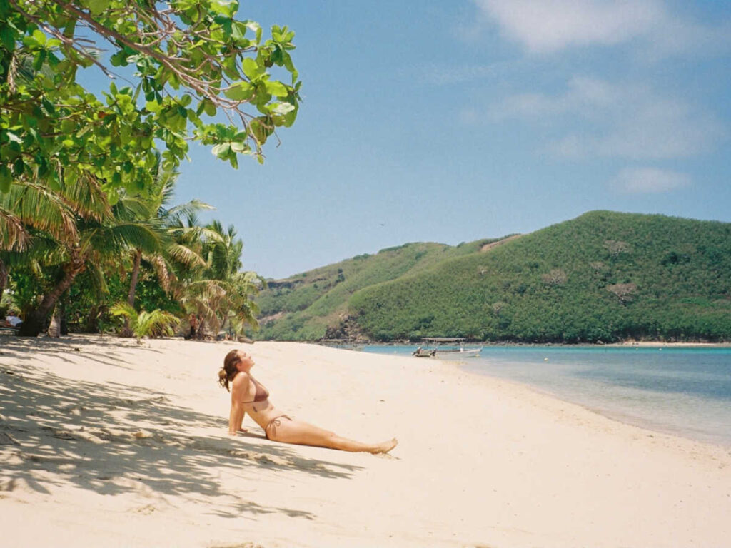 The author Laura McFarland relaxing on the beach in Manta Ray Island Resort