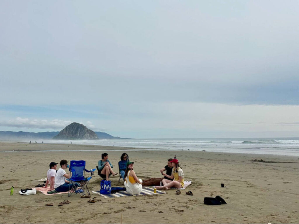The author Laura McFarland and her friends hanging out on Morro Strand with the view of the Morro Rock