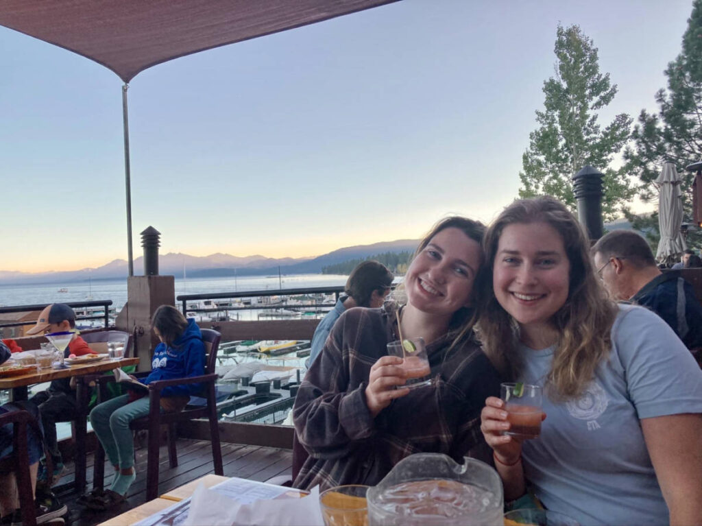 The author Laura McFarland and her friend drinking cocktails at Jake’s with an overlooking view