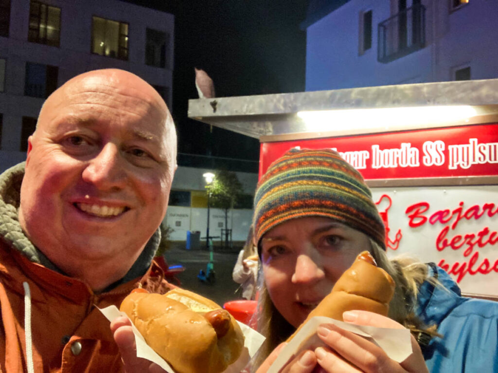 The author Laura and her husband holding their hotdog buns