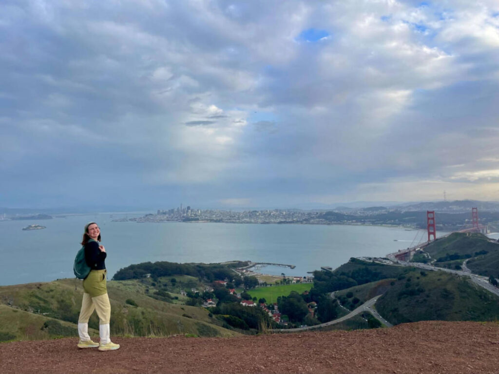 The author Laura McFarland posing atop Engagement Hill in the Marin Headlands