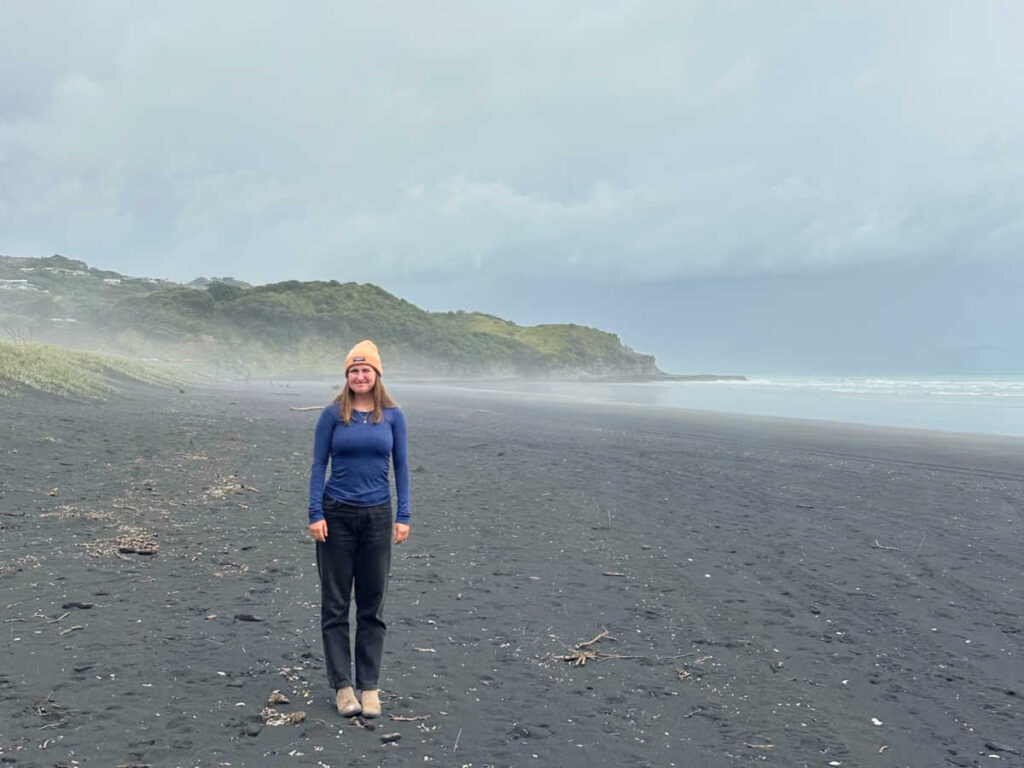 The author Laura McFarland at the foggy Muriwai Beach