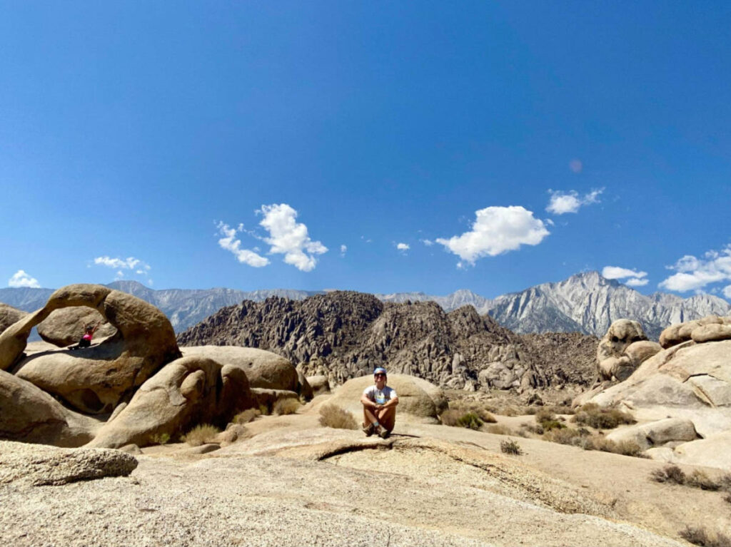 The author Laura McFarland, sitting with scenic views at the Alabama Hills