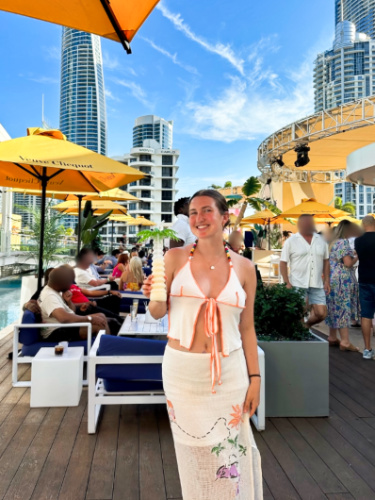 The author Laura McFarland at beach club in the Gold Coast with the crowd in the background
