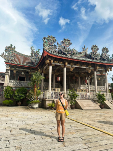 The author Laura McFarland wearing her Tevas sandals in front of the temple in Malaysia