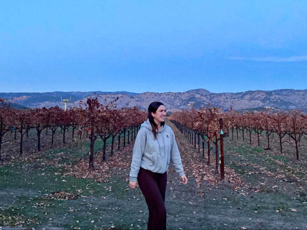 The author Laura McFarland with the view of the brown and dead vineyard