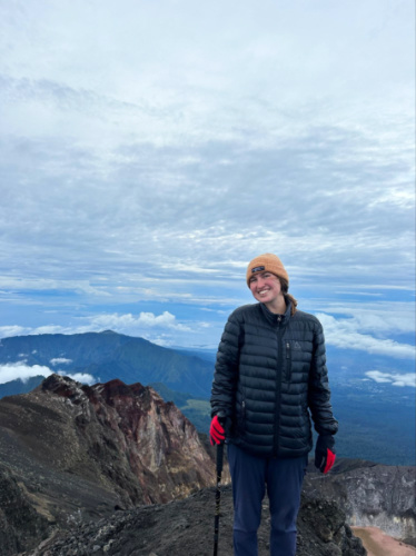 The author Laura McFarland wearing a puffer jacket while hiking on the volcanoes in Indonesia