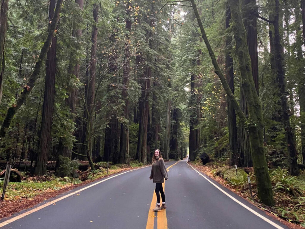 The author Laura McFarland posing for a photo in the middle of the highway