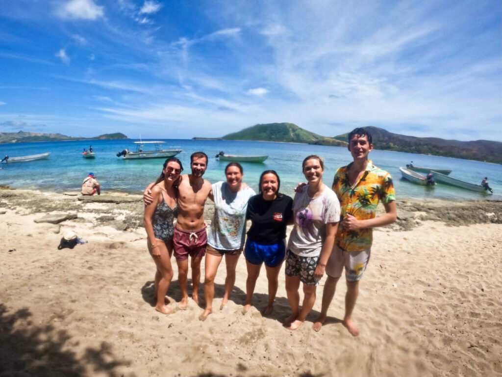 The author Laura McFarland and her partner with other tourists at the beach