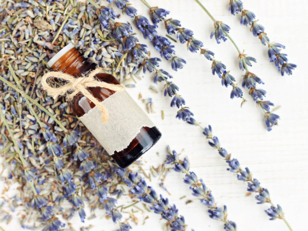 Lavender essential oil bottle decorated with twine bow and empty craft paper label