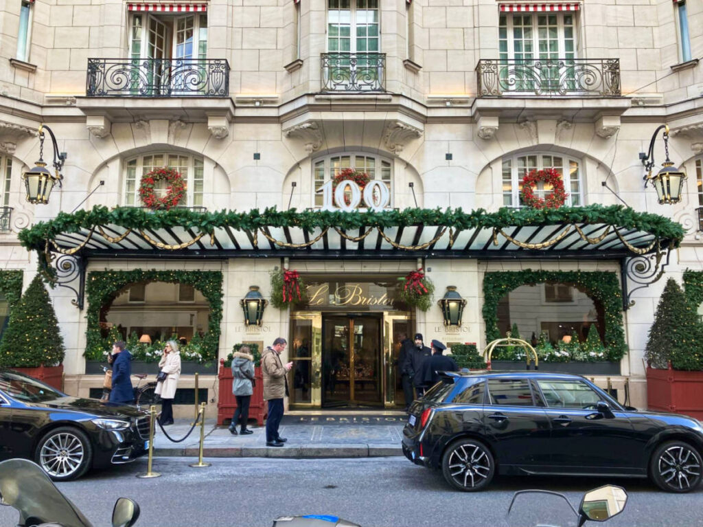 The exterior of Le Bristol Hotel with Christmas decorations around