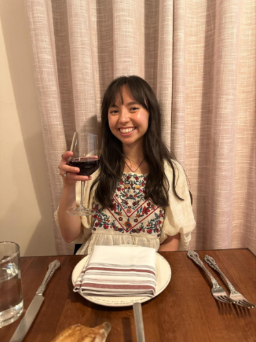 The author Lea Rose Allbaugh, holding a glass of red wine