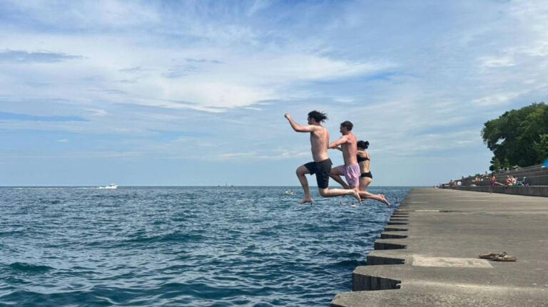 The author Lea Rose Allbaugh and her friends jumping into the Lake Michigan