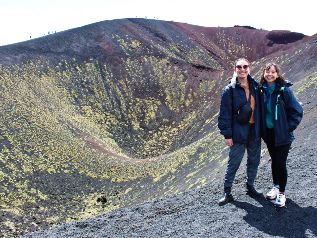 The author Lea Rose Allbaugh and her friend wearing windbreakers in Mount Etna