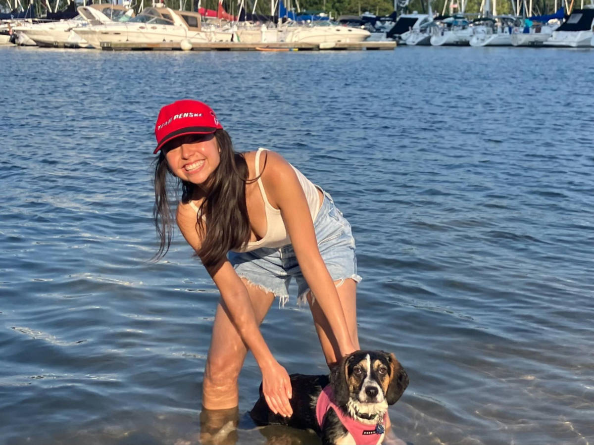 The author Lea Rose Allbaugh and her pup enjoying the water at the dog beach on a sunny day