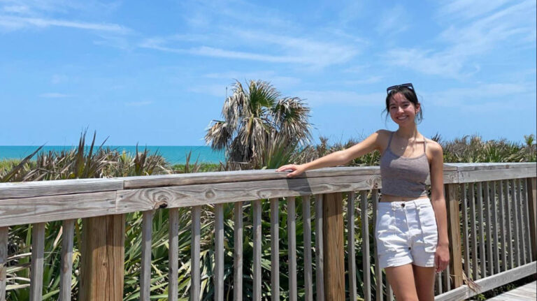 The author, Lea Rose, posing at the boardwalk of Hightower Beach Park