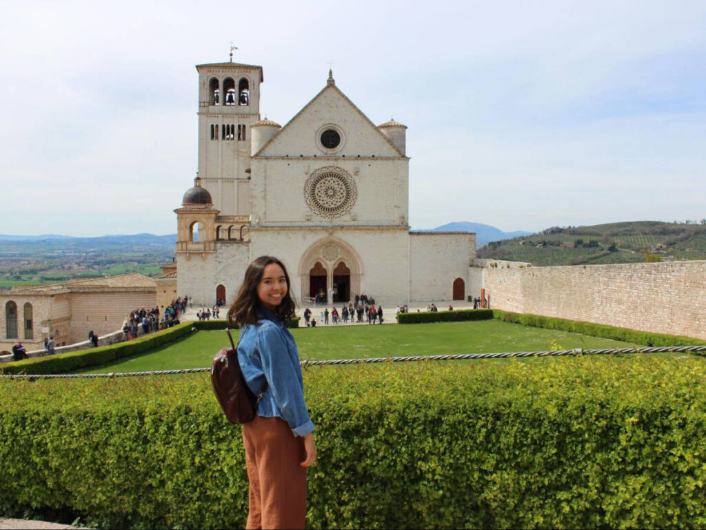 The author Lea Rose in front of the Papal Basilica and Sacred Convent of Saint Francis