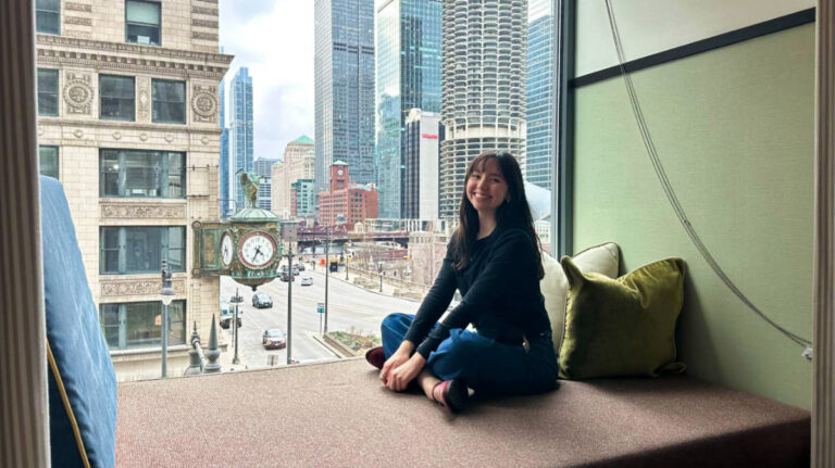 The author Lea Rose Allbaugh, sitting on the window nook at the L7 Chicago by Lotte Hotel