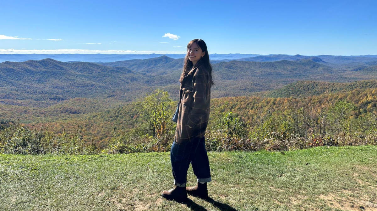 The author Lea Rose Allbaugh, enjoying the overlooking view surrounded by greenery at the Pisgah Inn