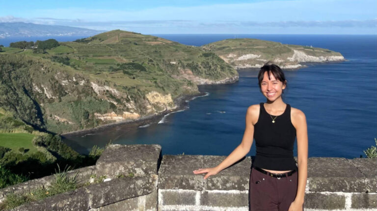 The author Lea Rose Allbaugh, smiling for a photo on one of the viewpoint in São Miguel Island
