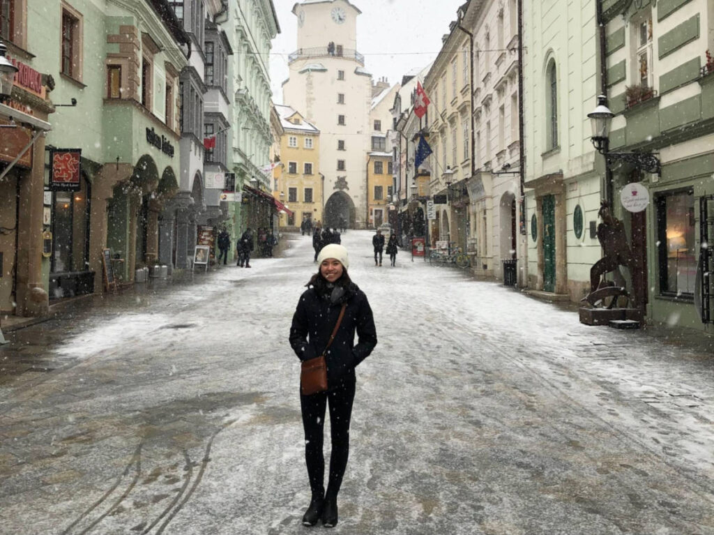 The author Lea Rose Allbaugh, posing for a photo in the middle of the street in Bratislava during winter season