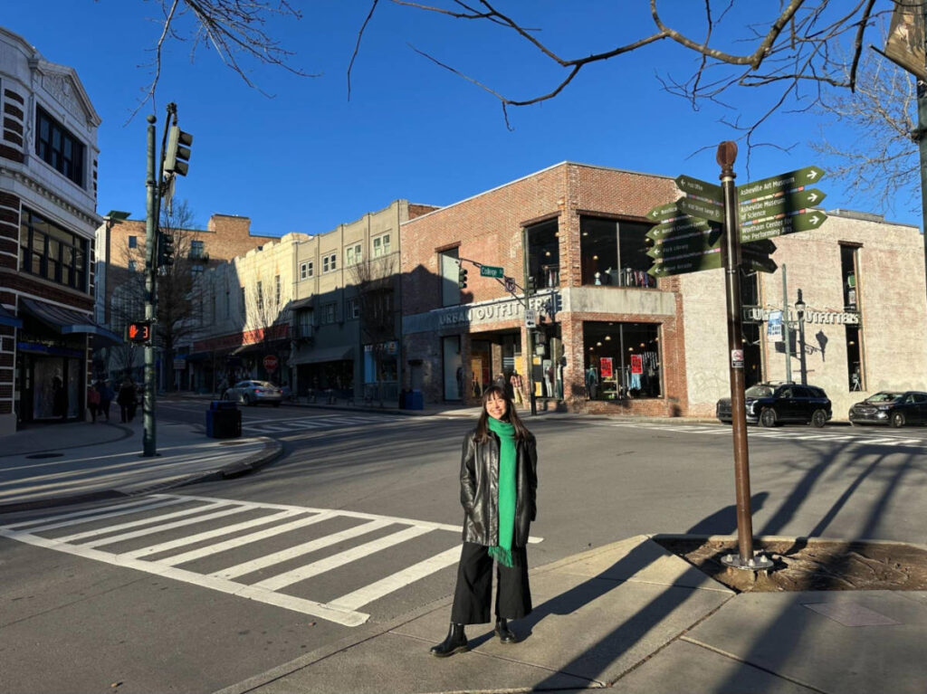 The author Lea Rose Allbaugh, standing in the quiet Downtown Asheville after Christmas