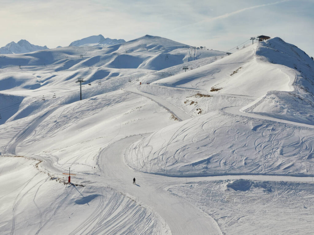 Skiers enjoying the slopes on Les Sybelles on a sunny day