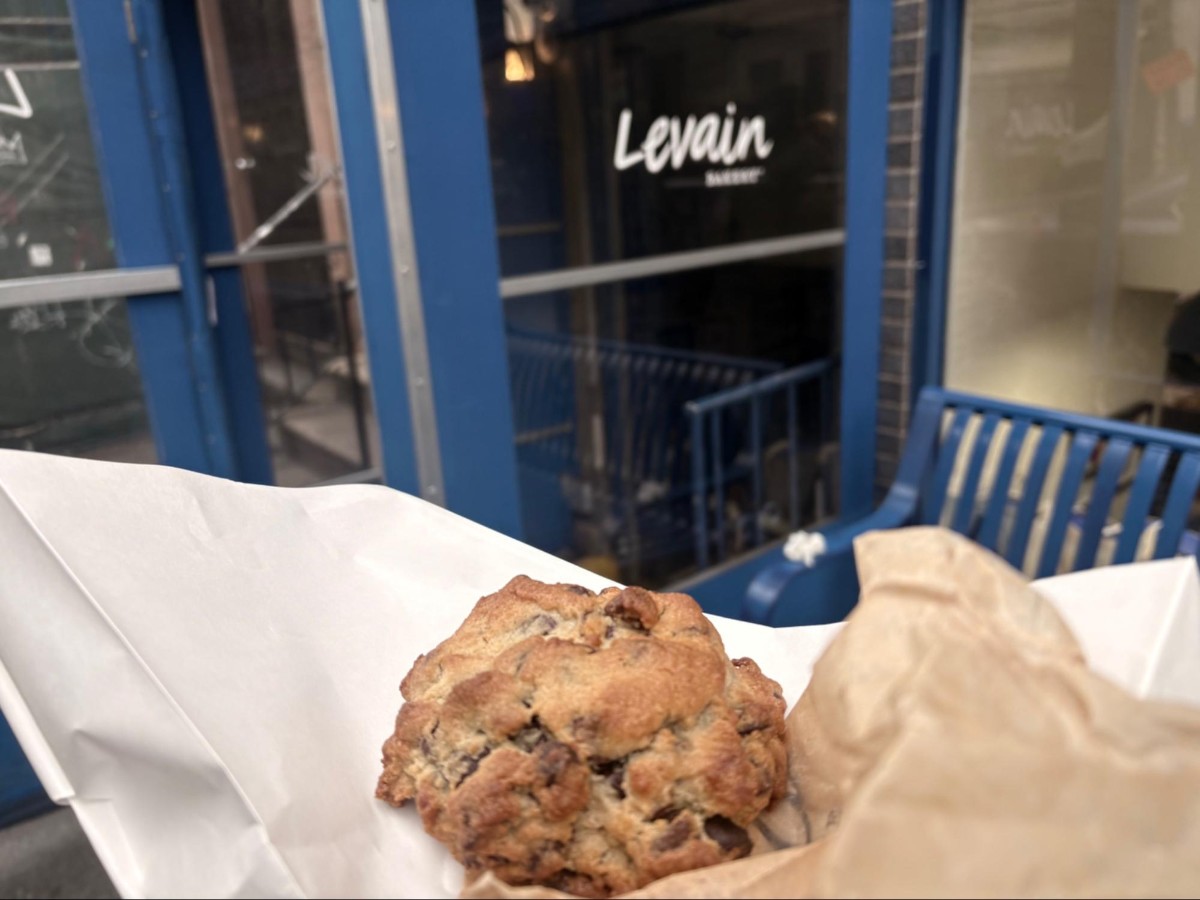 Holding a chocolate chip cookie from Levain Bakery W 74th
