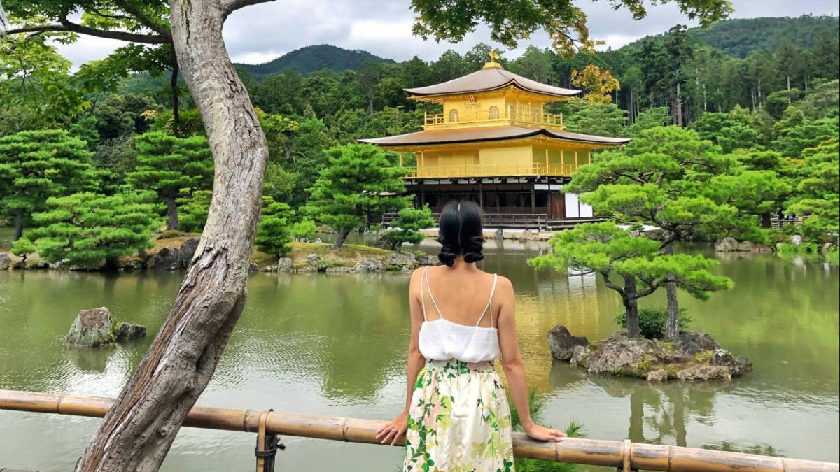 The author Lia Tee, admiring the Kinkakuji surrounded by the pond and greenery