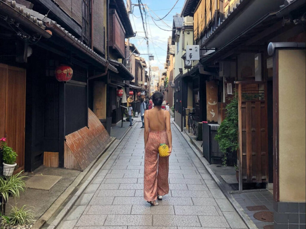 The author Lia Tee, walking along an alleyway in Gion