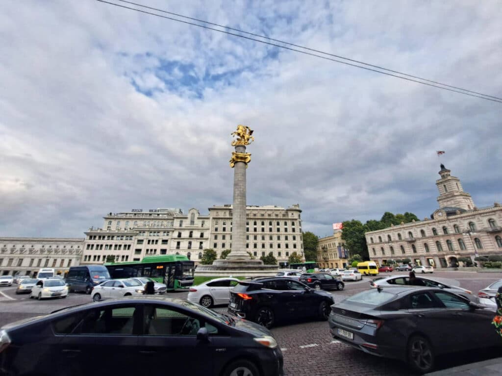 Buses and cars whirl around the Liberty Square in Tbilisi