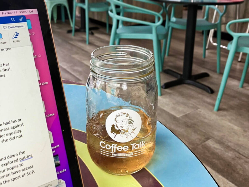 A glass with half empty of lilikoi iced tea at Talk Kaimuki