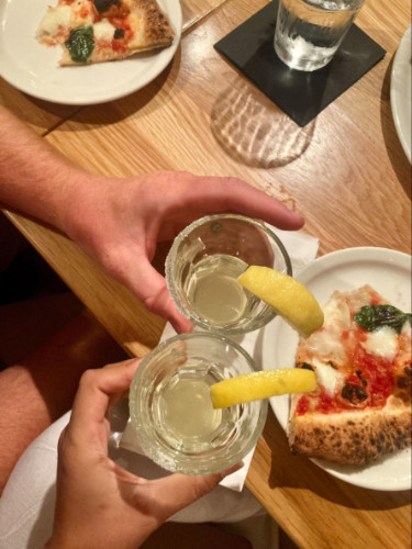 Travel Lemming Editor, Abigail having a cheers with her husband in Marco's Coal Fired