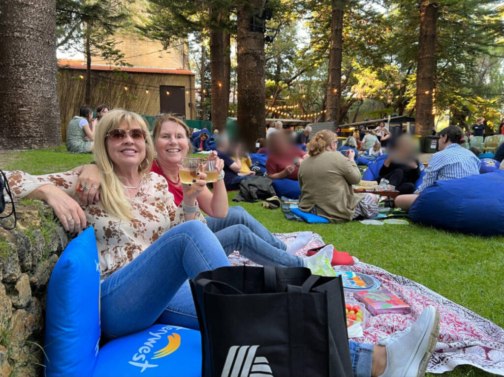 The author Lisa Ikin, enjoying at the Somerville Outdoor Movie while sitting on a picnic mat