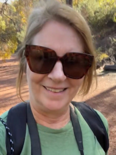 The author Lisa Ikin, smiling for a photo while hiking the Kittys Gorge Trail