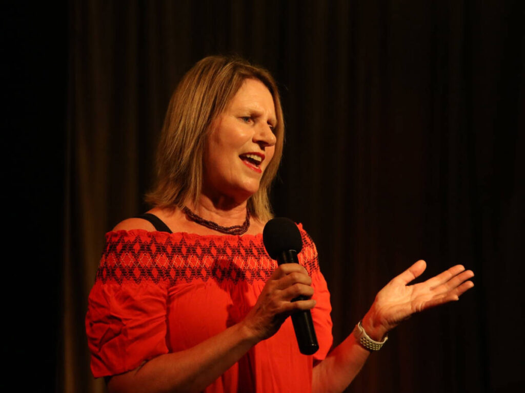 The author Lisa Ikin, delivering a speech on stage at Barefaced Stories