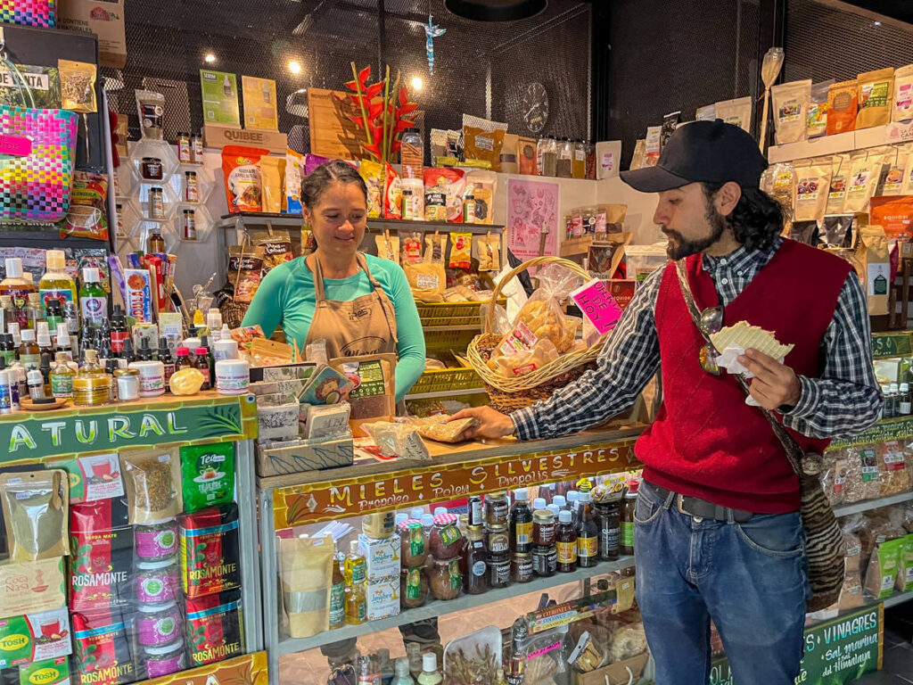 A man buying something on a local vendor in Bogota