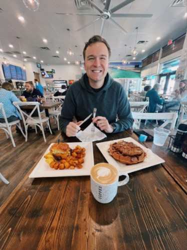 The author's husband enjoying a coffee and brunch in Destin