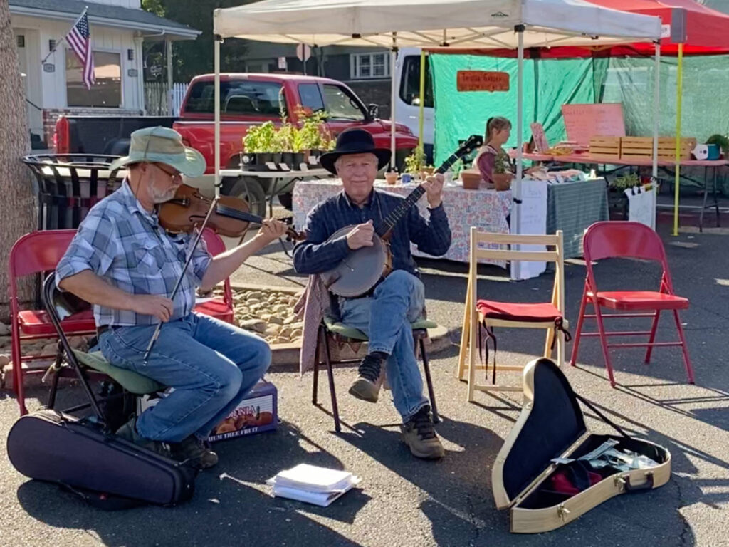 Two Local musicians busking at Sonora Farmers Market on the weekend