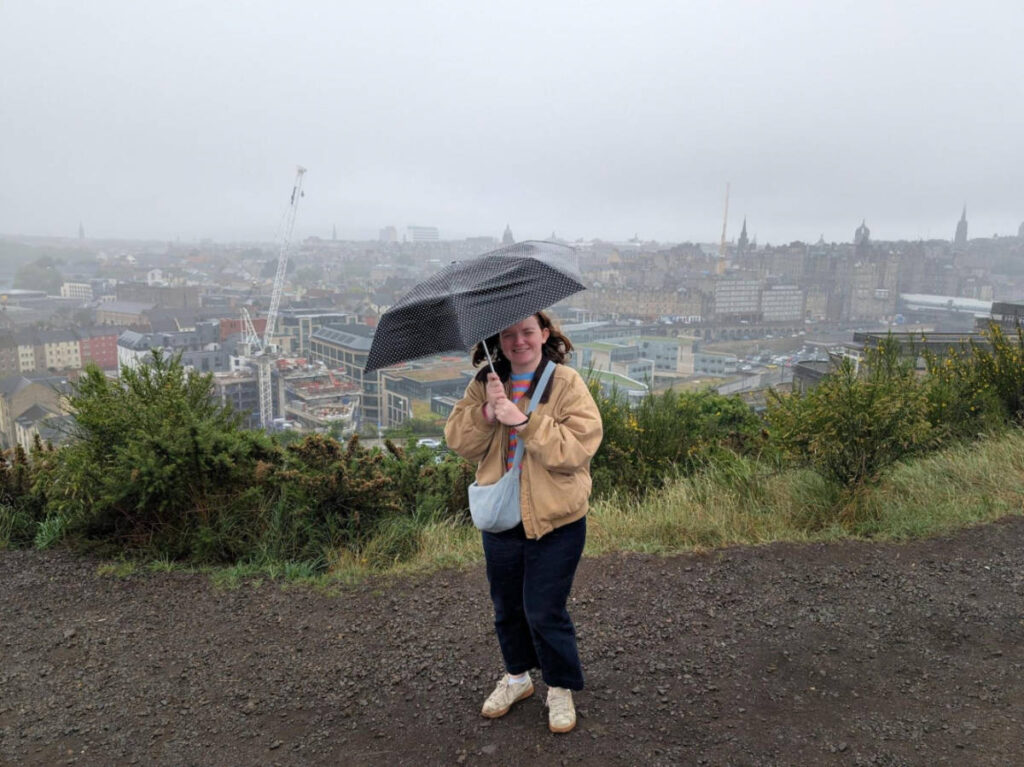 Travel Lemming writer Louise Wylie, holding an umbrella on a windy day