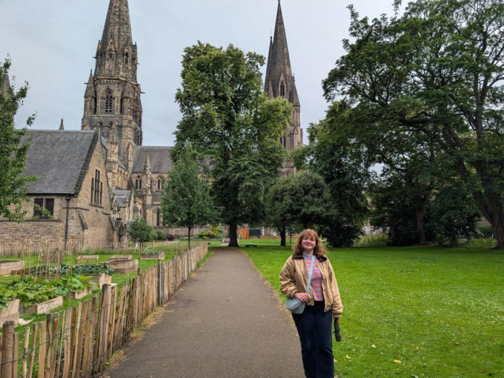 The author Louise Wylie posing for a photo in the grounds of St Mary’s Episcopal Cathedral