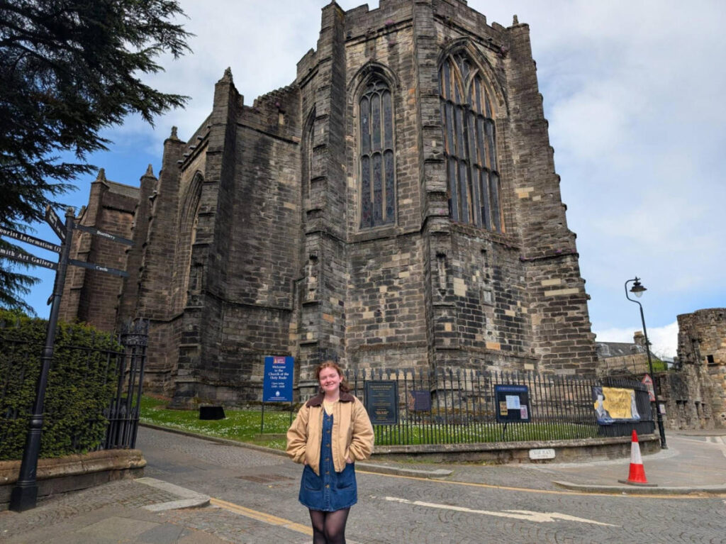 The author Louise Wylie, standing in front of the Church of the Holy Rude in Stirling